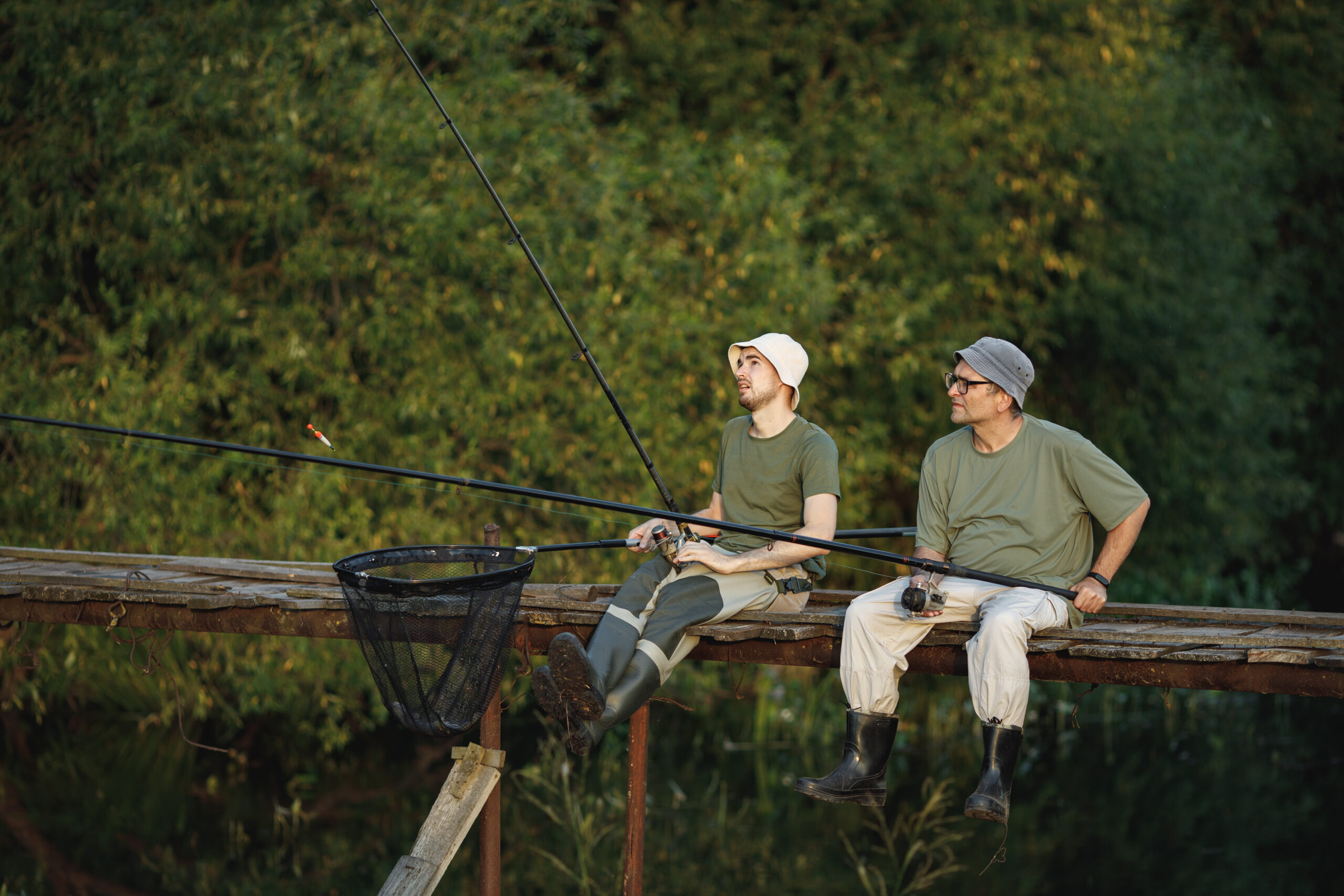 two fishermen with fishing rods on a footbridge ne 2026 01 06 10 00 55 utc